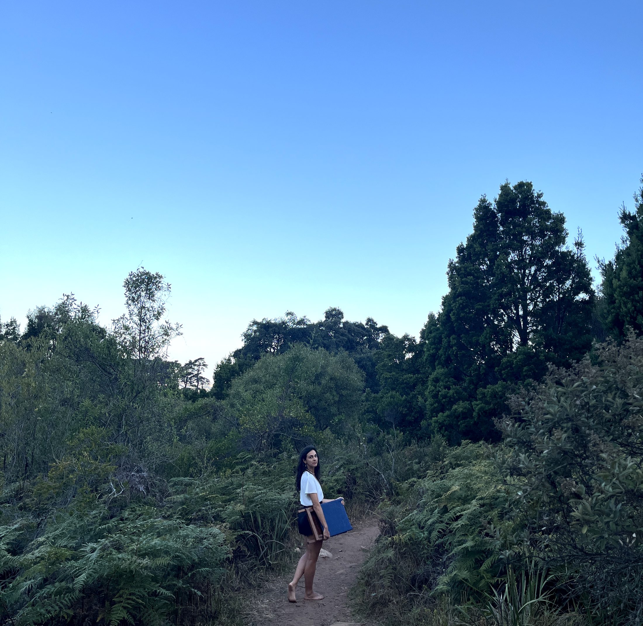 Carrying the folded kiaat chair along a mountain path